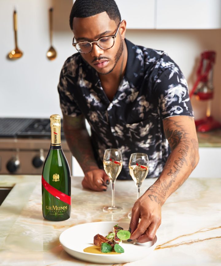 Chef Kwame finishing a dish with GH Mumm and two flutes
