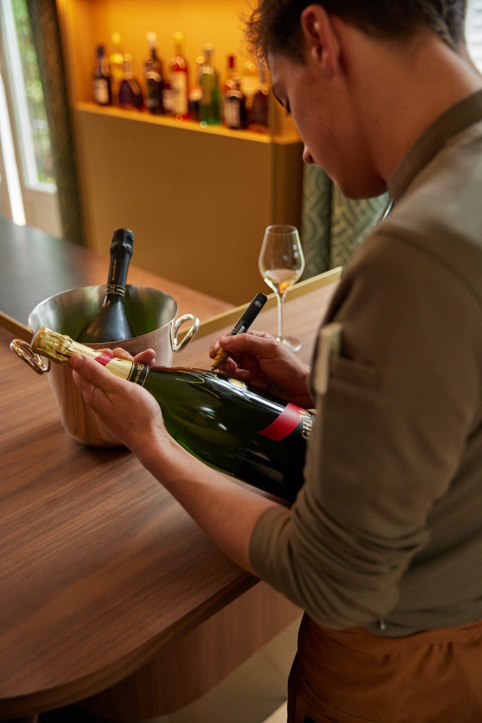 Chef Mallory signing bottle