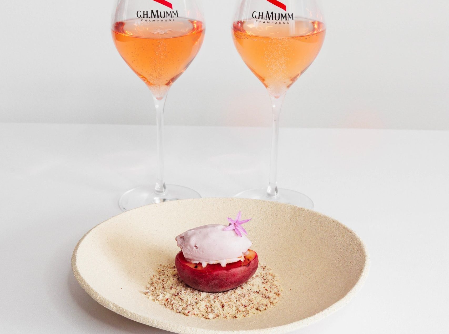 Roasted peaches with honey, red fruit ice cream, and pecan crumble - pairing Mumm Rosé - summer dessert