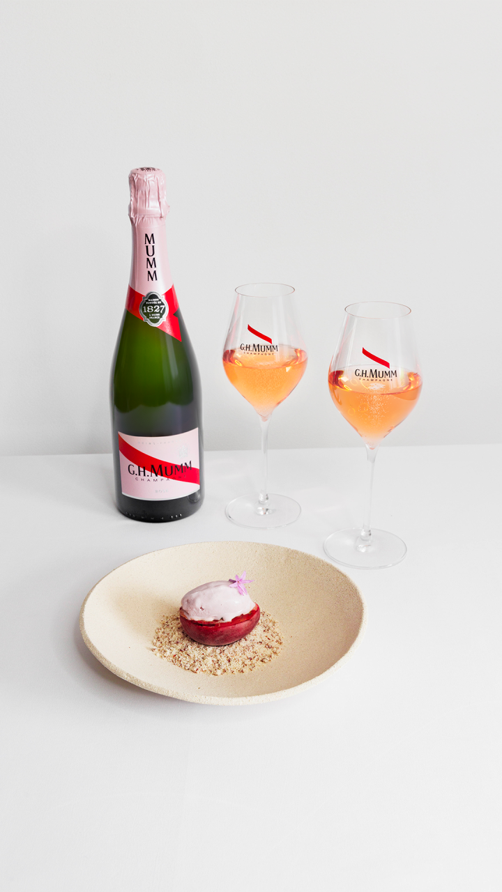 Roasted peaches with honey, red fruit ice cream, and pecan crumble